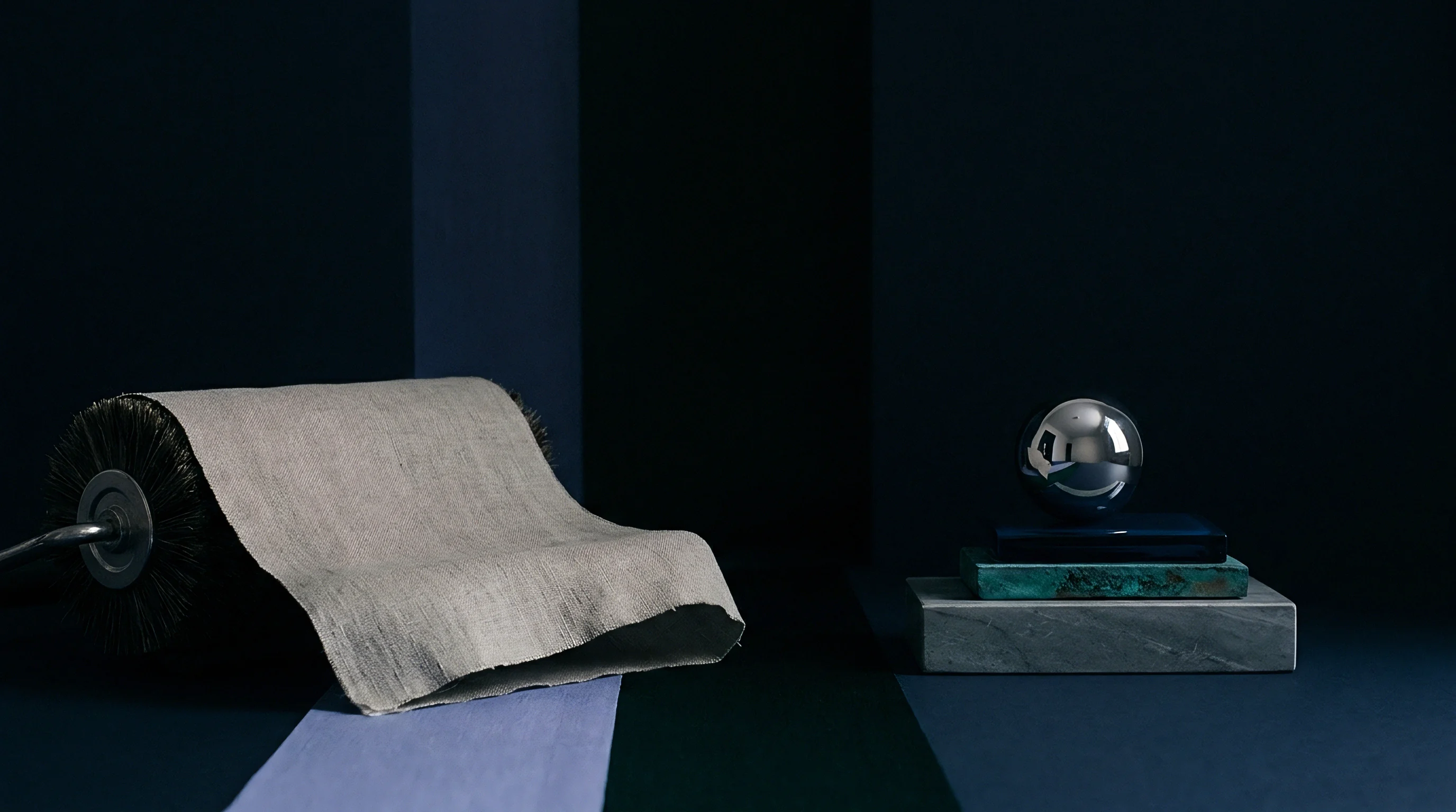 A digital render shows a woven flax textile draped over a cylindrical machine roller beside mineral blocks and a metallic sphere.
