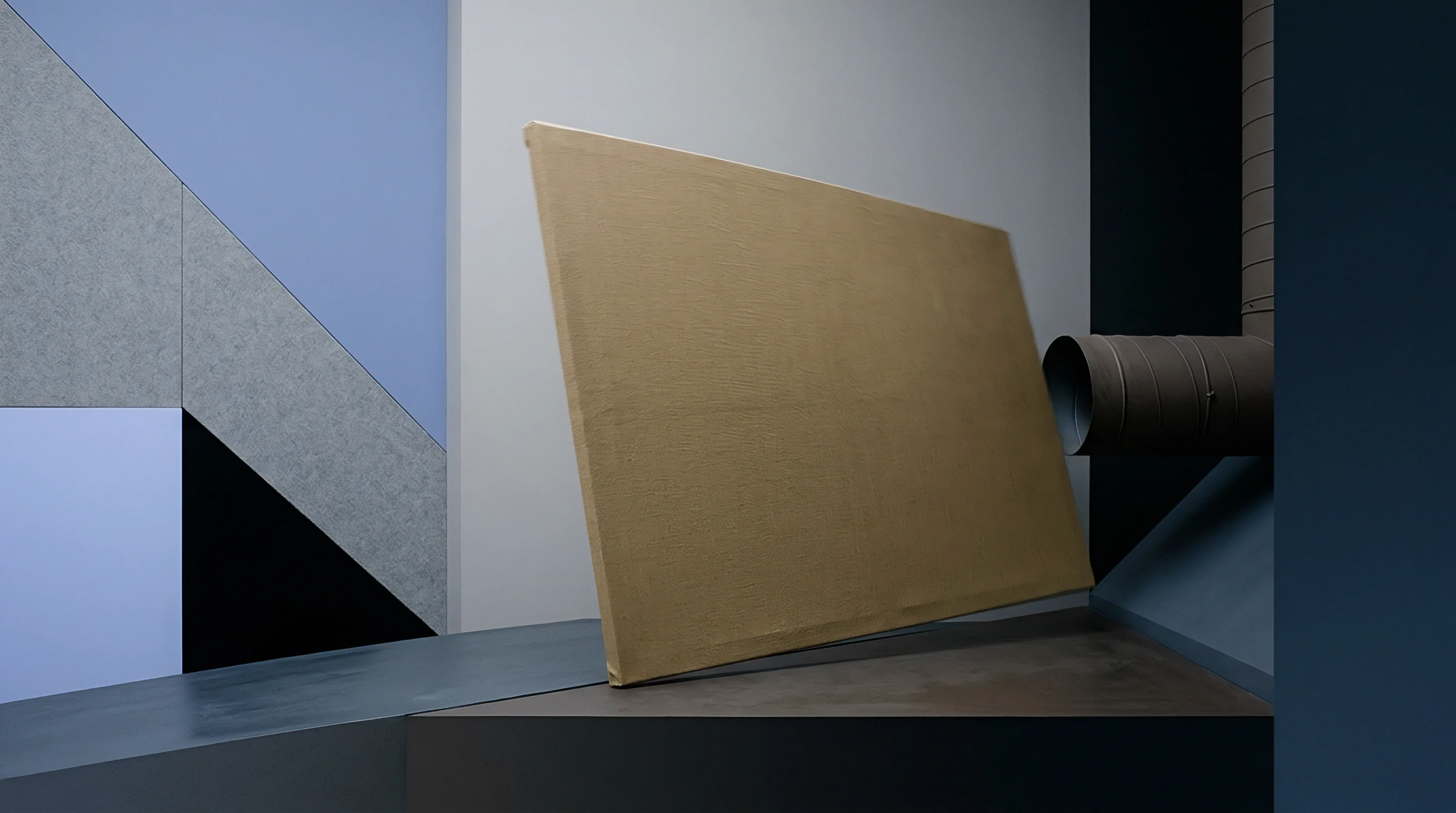 Unprimed woven textile stretched across a rigid rectangular frame rests against a geometric architectural wall surface.